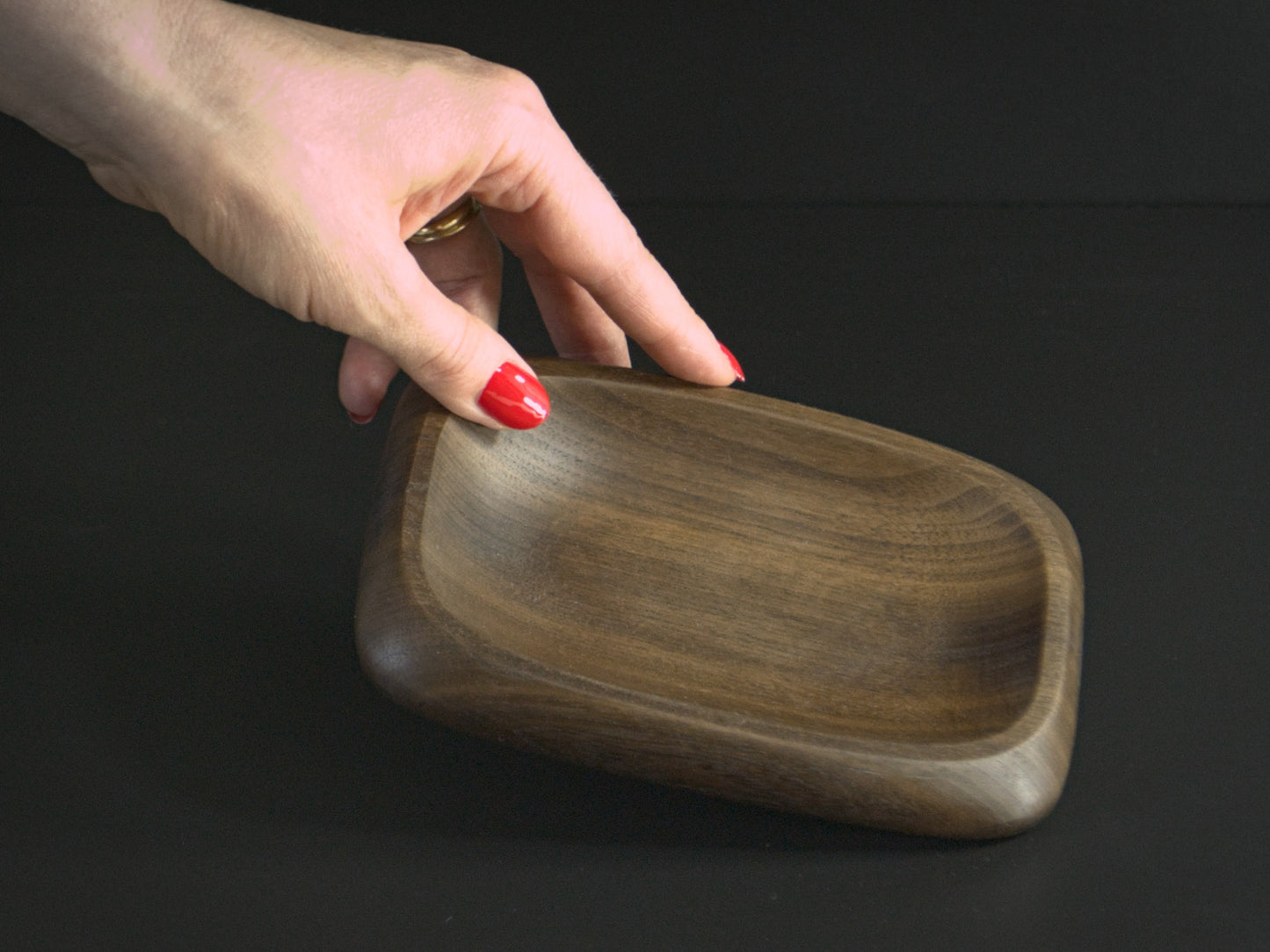 Small wooden tray and hand for scale